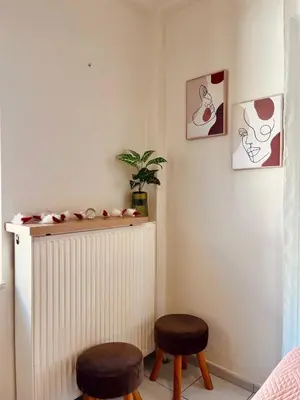 a living room with two stools and a radiator at Yasemi Chania Residences in Chania Town