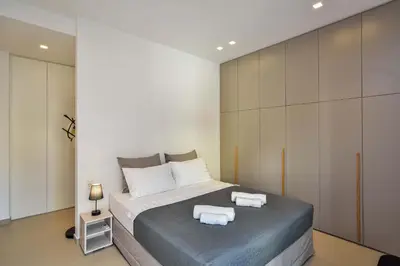 a bedroom with a bed with towels on it at Alex Downtown Holiday Apartment in Chania Town