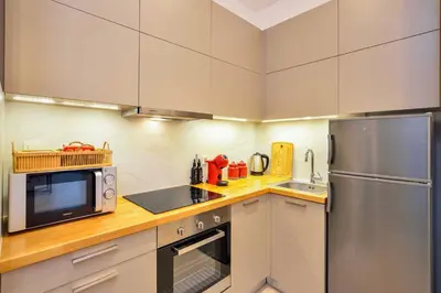 a kitchen with a stainless steel refrigerator and a sink at Alex Downtown Holiday Apartment in Chania Town