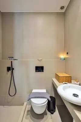 a bathroom with a toilet and a sink at Alex Downtown Holiday Apartment in Chania Town