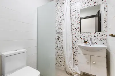 a bathroom with a toilet and a sink and a mirror at Central Bliss Apartment in Chania Town
