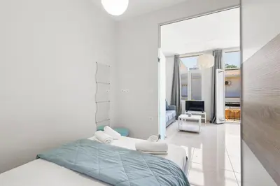 a bedroom with a bed and a large mirror at Central Bliss Apartment in Chania Town
