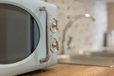 a microwave oven sitting on top of a table at Central Bliss Apartment in Chania Town