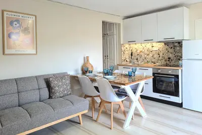 a kitchen and living room with a table and a couch at Liva apartments in Chania Town