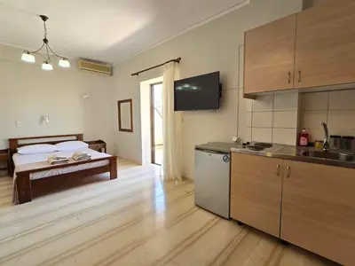 a room with a bed and a kitchen with a kitchen at Liva apartments in Chania Town