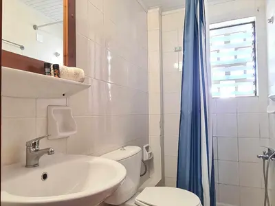 a white bathroom with a sink and a toilet at Liva apartments in Chania Town