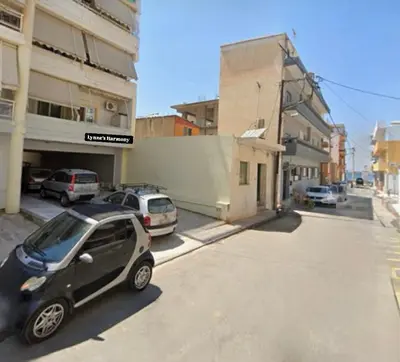 a small car parked on the side of a street at Lynne's Harmony Chania Beach Studio in Chania Town