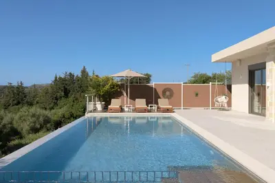 a swimming pool in the backyard of a house at Reflection Villa, Heated Pool & Absolute Seclusion, By ThinkVilla in Chania Town