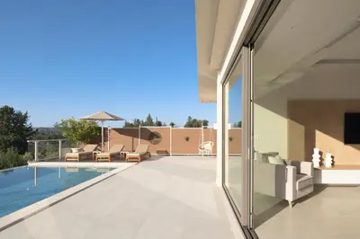 an external view of a house with a swimming pool at Reflection Villa, Heated Pool & Absolute Seclusion, By ThinkVilla in Chania Town