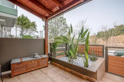 a balcony with a bench and a plant at Modern Studio 2 with a Yard in Chania Town