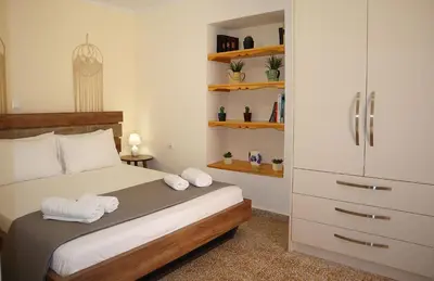 a bedroom with a bed with towels on it at Dimitriοs Stone House in Chania Town