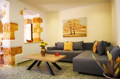 a living room with a couch and a table at Dimitriοs Stone House in Chania Town