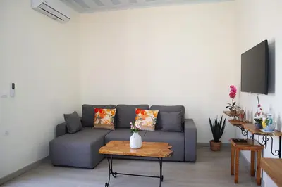 a living room with a blue couch and a table at Dimitriοs Stone House in Chania Town
