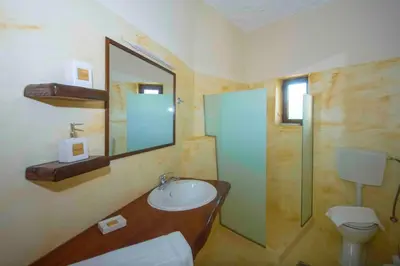 a bathroom with a sink and a toilet and a mirror at Skaros Cottage in Chania Town