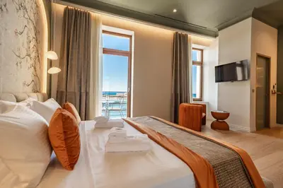 a bedroom with a large bed with a large window at MiraVita Boutique Hotel - Adults Only in Chania Town