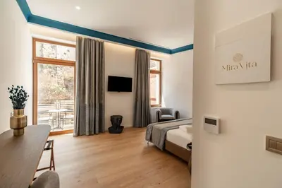 a hotel room with a bed and a window at MiraVita Boutique Hotel - Adults Only in Chania Town