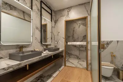 a bathroom with two sinks and a shower at MiraVita Boutique Hotel - Adults Only in Chania Town