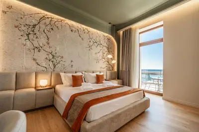 a bedroom with a bed and a couch and a window at MiraVita Boutique Hotel - Adults Only in Chania Town