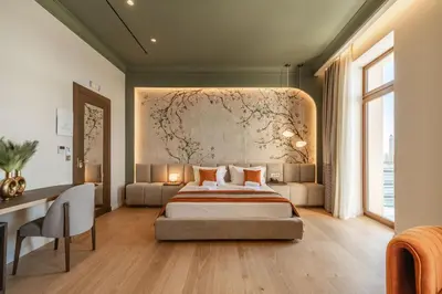 a bedroom with a large bed and a desk at MiraVita Boutique Hotel - Adults Only in Chania Town