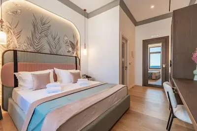 a bedroom with a large bed and a desk at MiraVita Boutique Hotel - Adults Only in Chania Town
