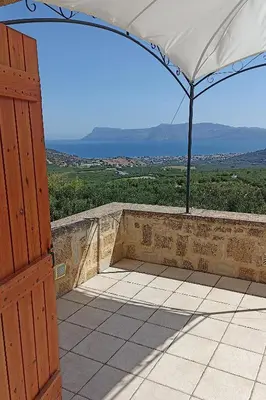 an open door to a patio with an umbrella at Mulberry Hill - amazing panoramic views - Kissamos in Kissamos
