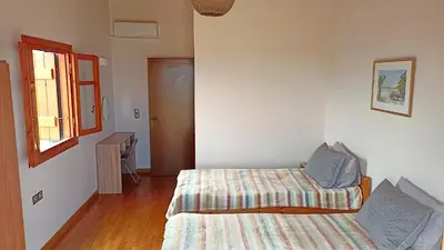 a small bedroom with a bed and a window at Mulberry Hill - amazing panoramic views - Kissamos in Kissamos