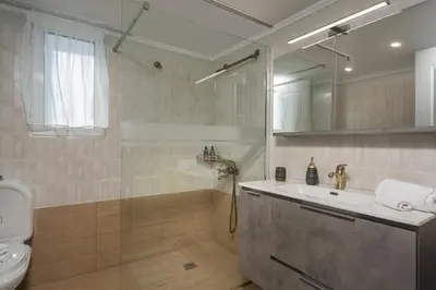 a bathroom with a tub and a sink and a shower at Mystique Sunset View in Chania Town