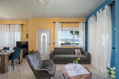 a living room with a couch and a table at Mystique Sunset View in Chania Town