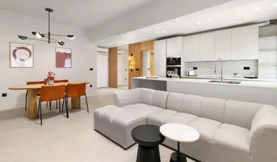 a living room and kitchen with a couch and a table at CRETA ELENA SUITE in Chania Town