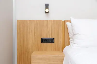 a room with a bed and a wall with a clock at CRETA ELENA SUITE in Chania Town