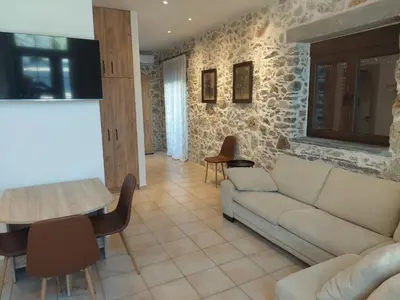a living room with a couch and a table at Elaion Apartments in Kántanos