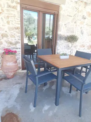 a wooden table and chairs on a patio at Elaion Apartments in Kántanos