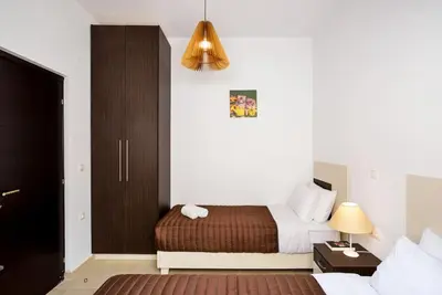 a hotel room with a bed and a nightstand and a bed sidx sidx sidx at Livaniana Panoramic View house 2 in Livanianá