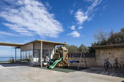 a play structure with a slide and a playground at Virtus in Mare in Tsivarás