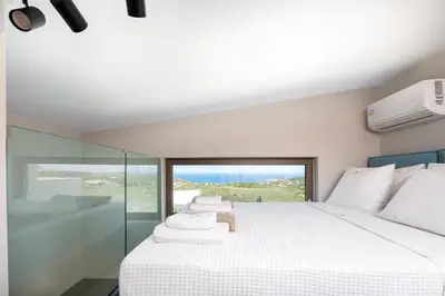 a bedroom with a large bed with towels on it at Virtus in Mare in Tsivarás