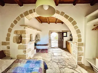 a room with a stone archway with a bed in it at Villa ABBA in Plaka