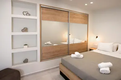 a bedroom with a large window with towels on a bed at Garden house in Kissamos