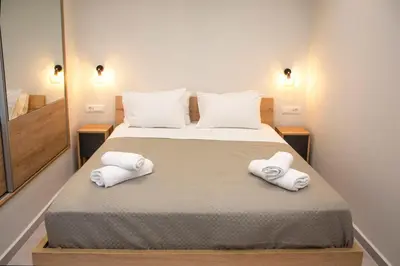 a bedroom with a bed with two towels on it at Garden house in Kissamos
