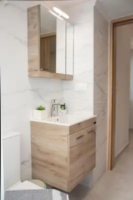a bathroom with a sink and a mirror at Garden house in Kissamos