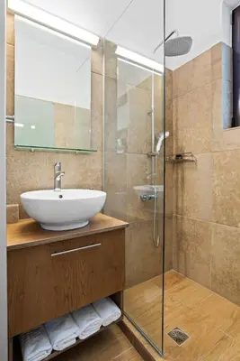 a bathroom with a sink and a glass shower at Kera Green Villa in Kalyves