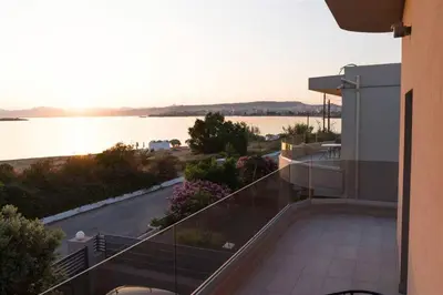 a balcony of a building with a view of the water at Riviera Seafront Balcony in Evthími