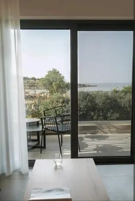 a room with a view of the ocean from a house at Riviera Seafront Balcony in Evthími