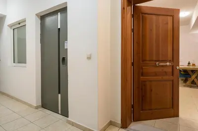a hallway with a wooden door in a room at Urban Oasis Central in Chania Town