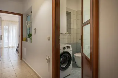 a bathroom with a washing machine and a toilet at Urban Oasis Central in Chania Town