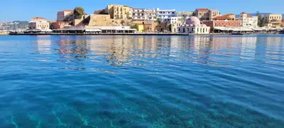 a large body of water with a city in the background at Old Town Loft with Sea View Roof Terrace and Private Parking in Chania Town