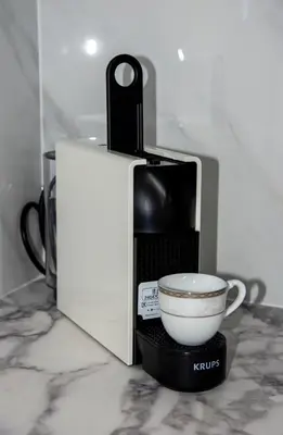 a coffee maker with a cup on a counter at FRDomus in Daratso