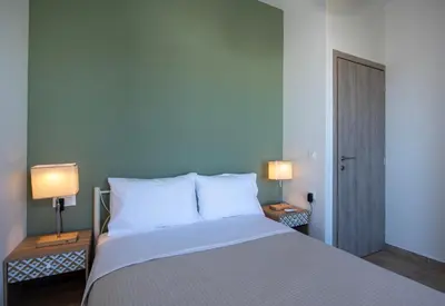 a bedroom with a bed with two lamps on two tables at FRDomus in Daratso