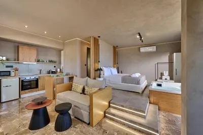 a living room with a couch and a bed in a room at Nami Suites - Alenia in Chania Town