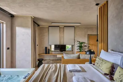 a bedroom with a bed and a bath room at Nami Suites - Alenia in Chania Town