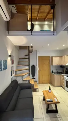 a living room with a couch and a table at Duplex apartment city center in Chania Town